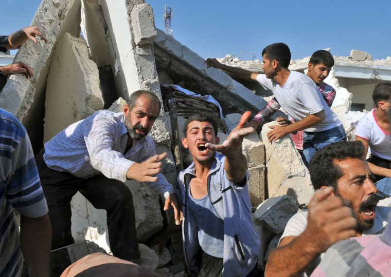Image: A Syrian man reacts as they look for peo